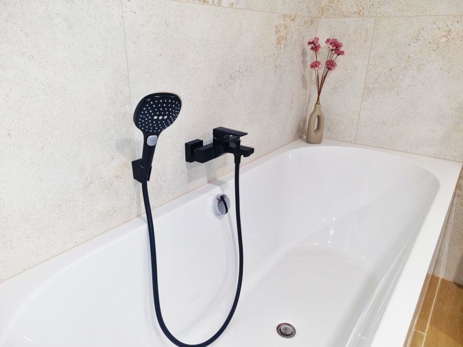 Detail vany s černou vanovou baterií a ruční sprchou. Rekonstrukce koupelny a interiéru bytu Svitavy, Hradec Králové | Pemtrade.cz